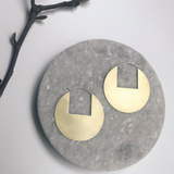 Large brass disc hoops with geometric cutout on Sterling