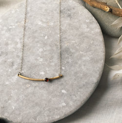 Curved brass bar necklace with carnelian