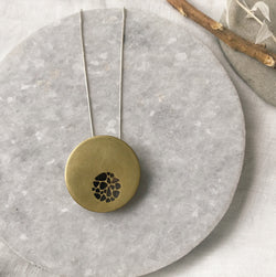 Hollow brass pebble circle cutout necklace