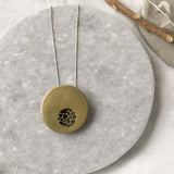 Hollow brass pebble circle cutout necklace