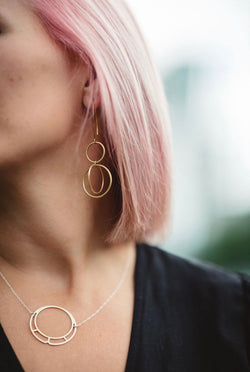 Kinetic brass hoop within hoop earrings